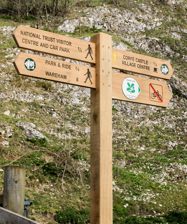 Wooden Fingerpost Sign with engraved, infilled lettering and recessed bespoke waymarker discs. Wooden Fingerpost Sign with engraved, infilled lettering and recessed bespoke waymarker discs.
