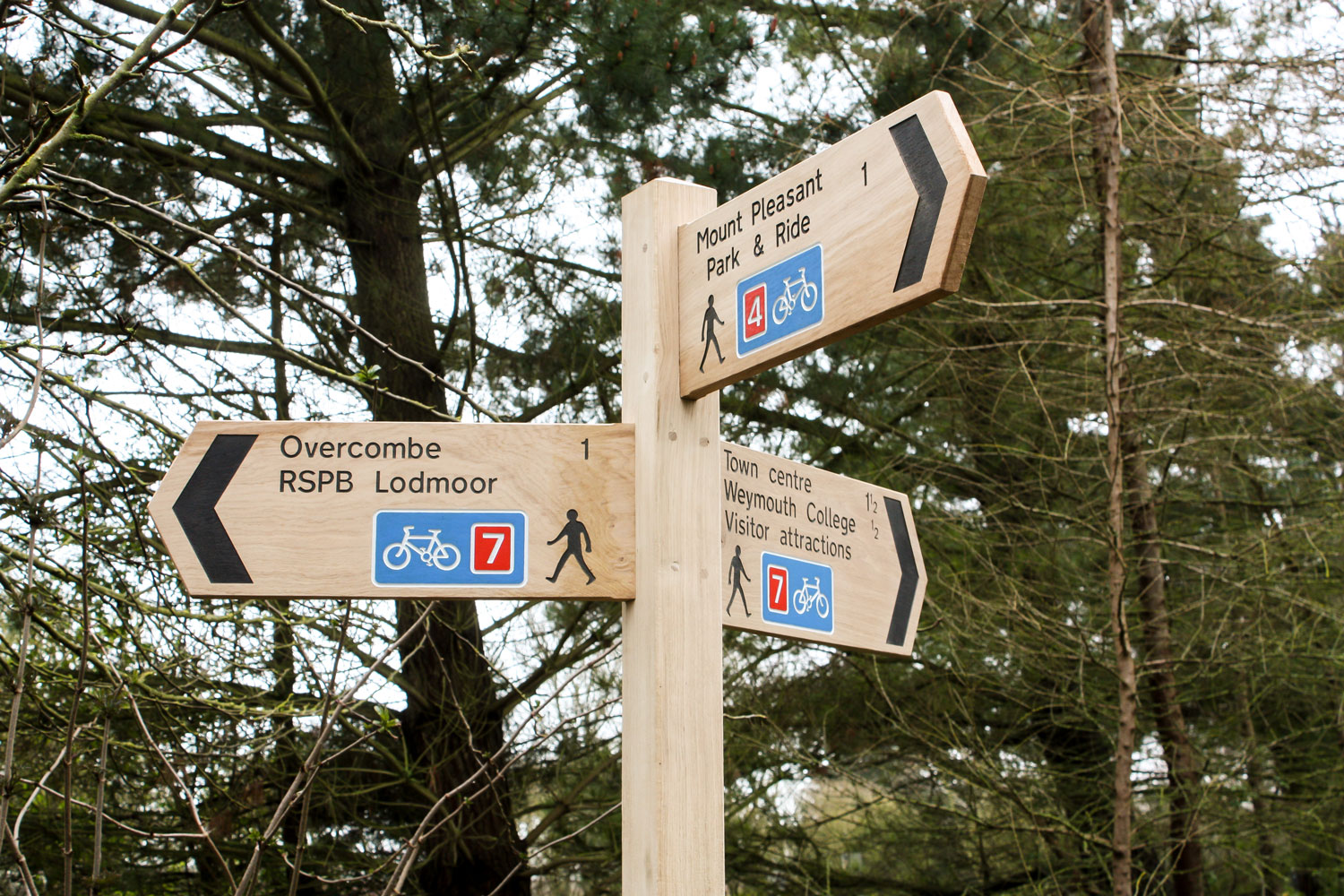 Wooden Fingerpost Sign made from English Oak with bespoke multi coloured symbol and lettering. Wooden Fingerpost Sign made from English Oak with bespoke multi coloured symbol and lettering.